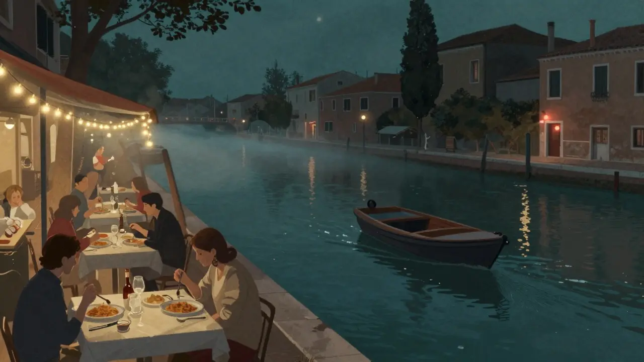 Naviglio Grande canal at night with outdoor dining and string lights reflecting on water.